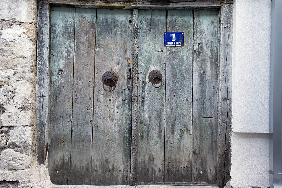 Photo 26209: Worn, carved, green and unpainted gate of boards