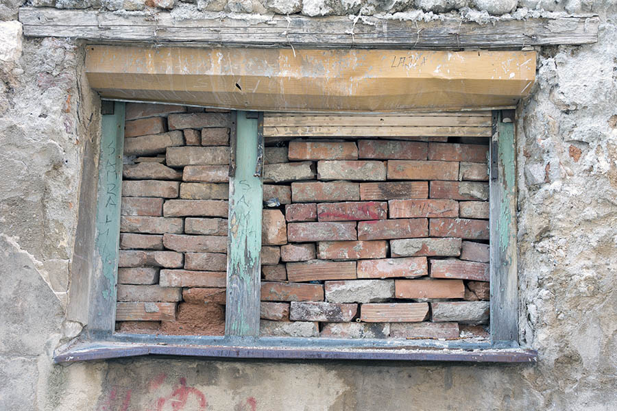 Photo 26221: No window: A decayed, light green window blocked with red bricks without mortar