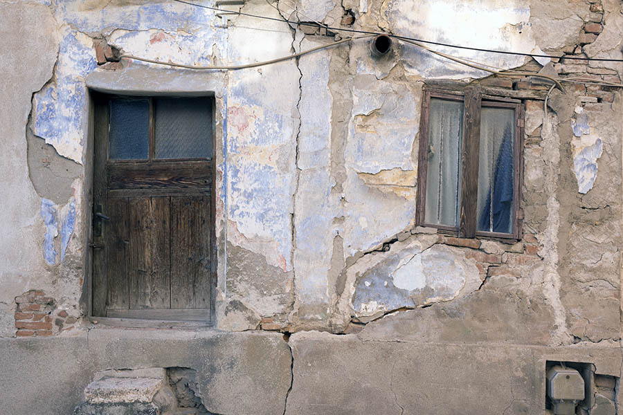 Photo 26367: Facade with low, brown door and a lopsided, brown window
