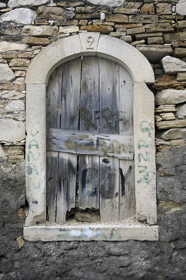 Photo 26588: No window. Unpainted, formed window stone frame blocked by boards