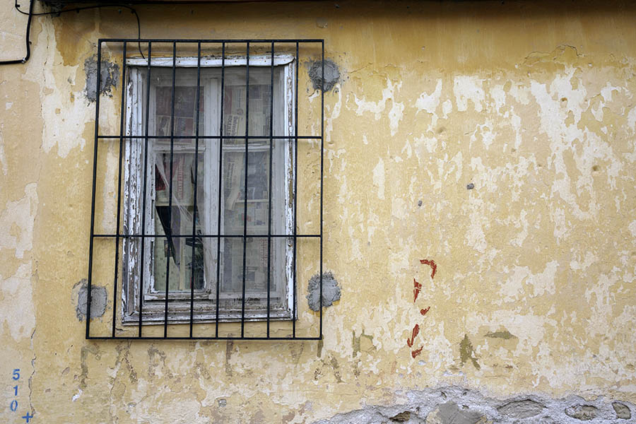 Photo 26620: Decayed, white window with grating