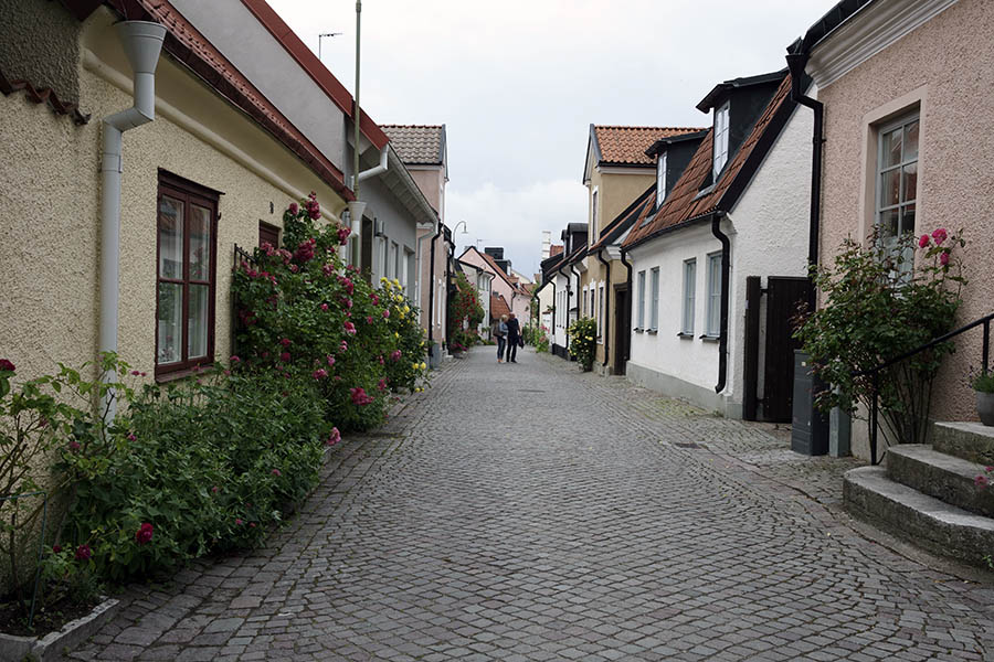 Photo 27137: Yellow, pink and white facades in street in Visby, Sweden