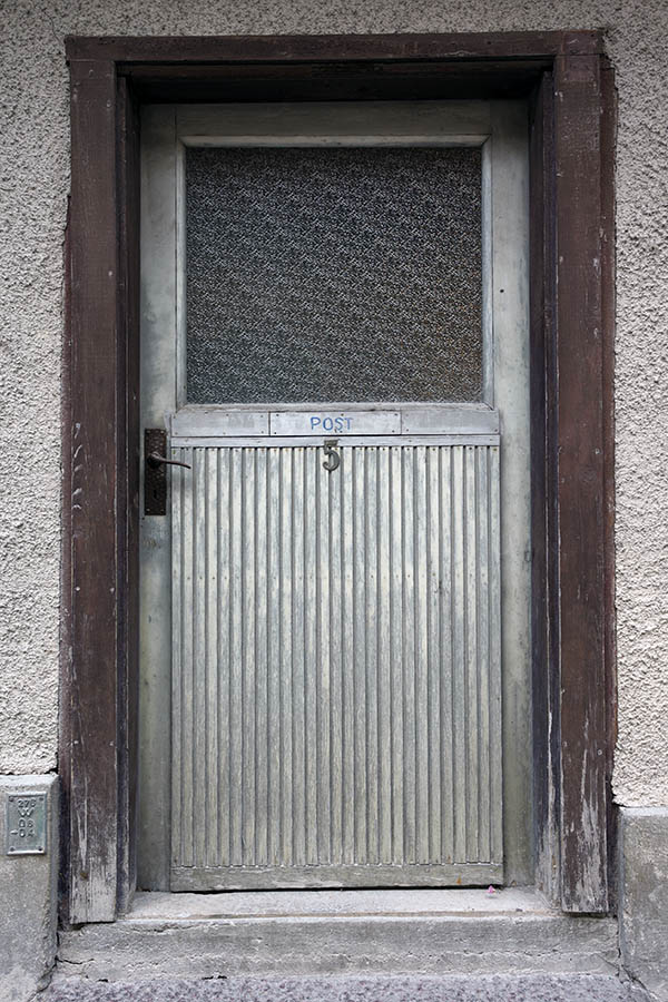 Photo 27160: Worn, grey door with door light with matted glass in a brown frame