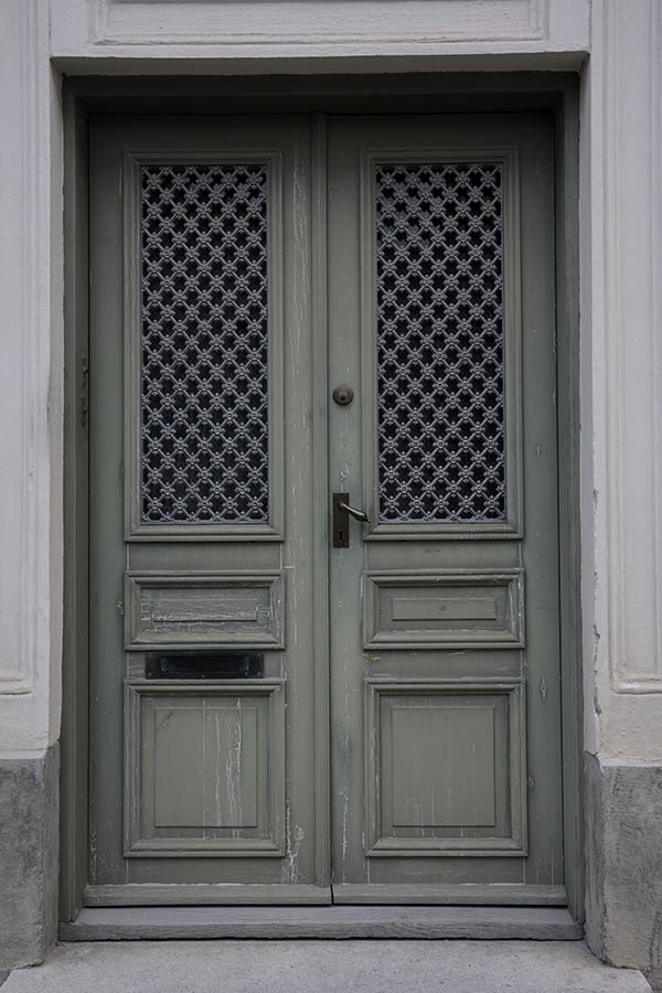Photo 27172: Worn, green, panelled double door with grey, latticed windows 
