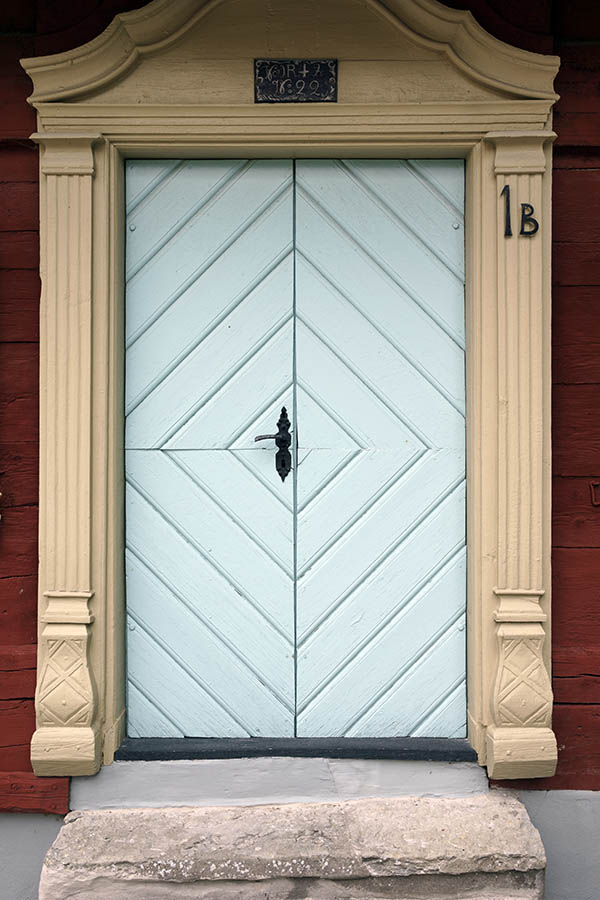 Photo 27207: Light blue double door of boards in diamond shape with light yellow, carved pilastre