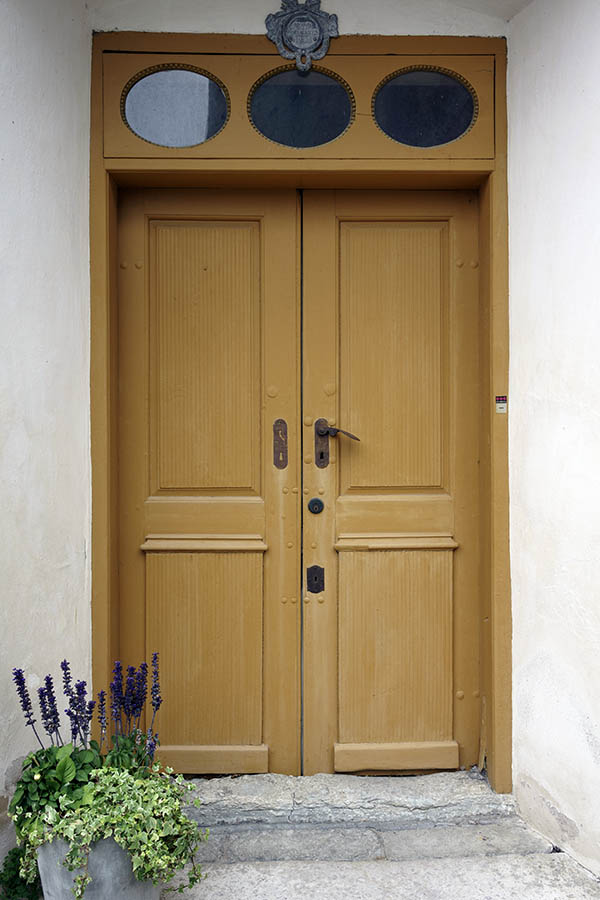 Photo 27210: Panelled, carved, yellow double door with oval top windows