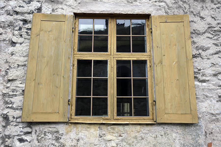 Photo 27219: Yellow window with four frames, 20 panes and shutters.