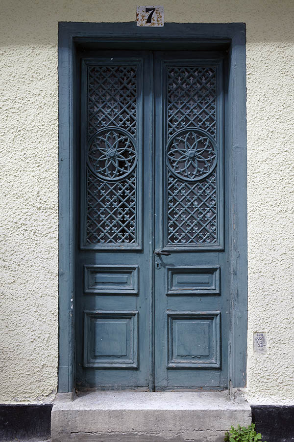 Photo 27289: Worn, teal, panelled double door with latticed door lights
