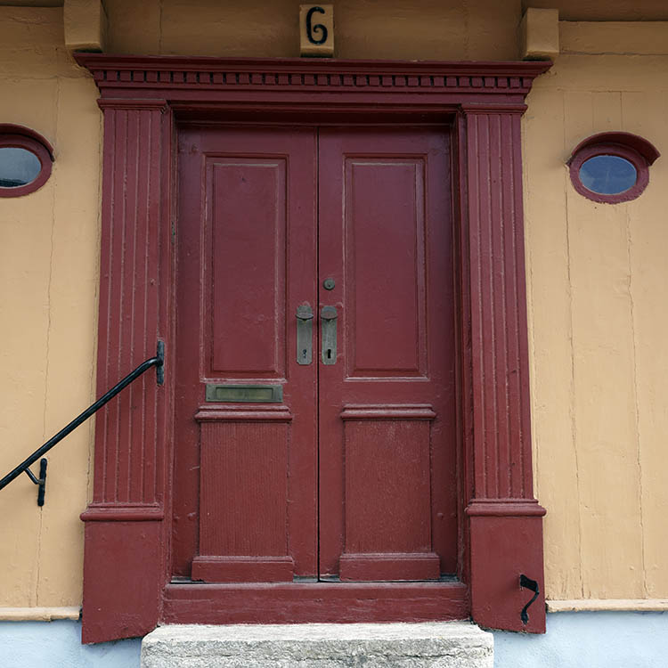 Photo 27328: Carved, panelled, red double door in a carved pilastre