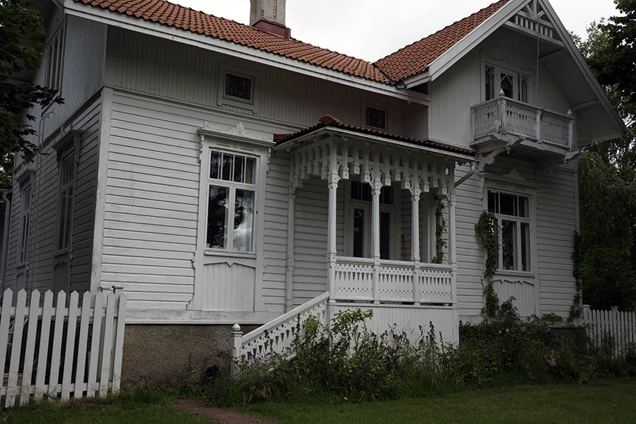 Photo 27364: Facade of white, wooden villa with carved veranda
