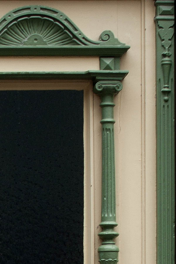 Photo 00231: Panelled, carved double door in green and light yellow colours
