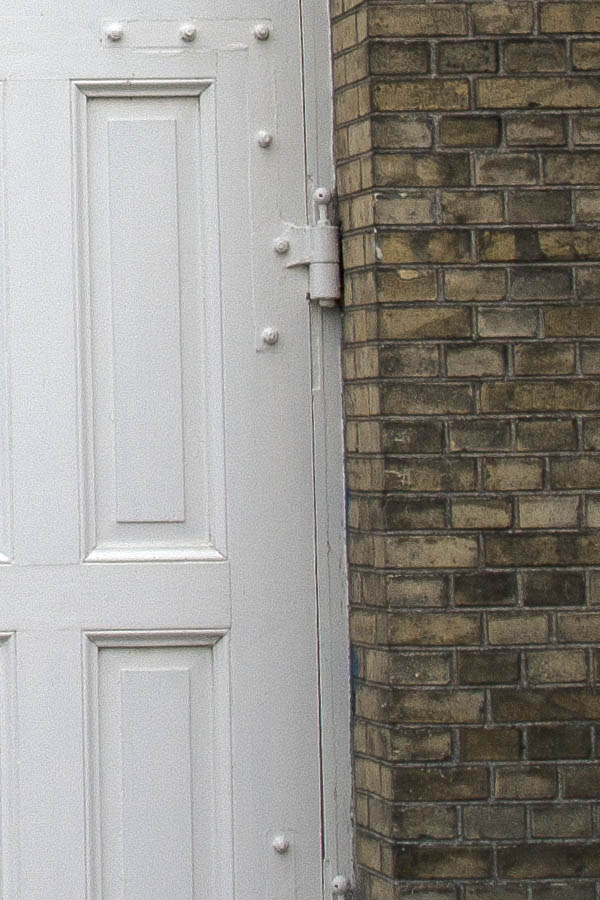 Photo 01410: Large, panelled, formed, white gate with minor door and fan light