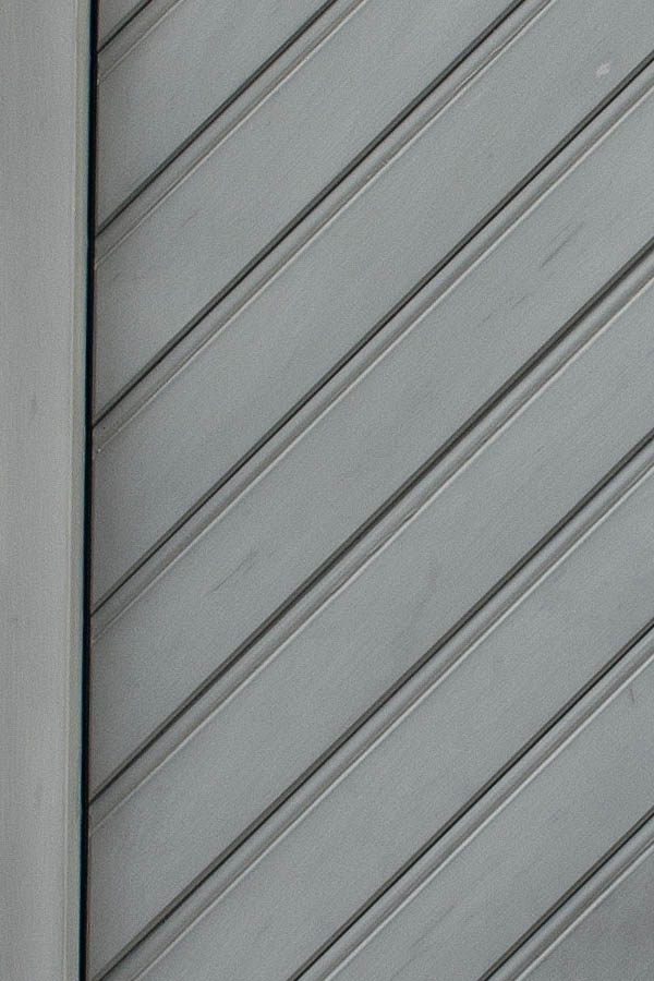 Photo 01791: Panelled, light grey door with diagonal boards