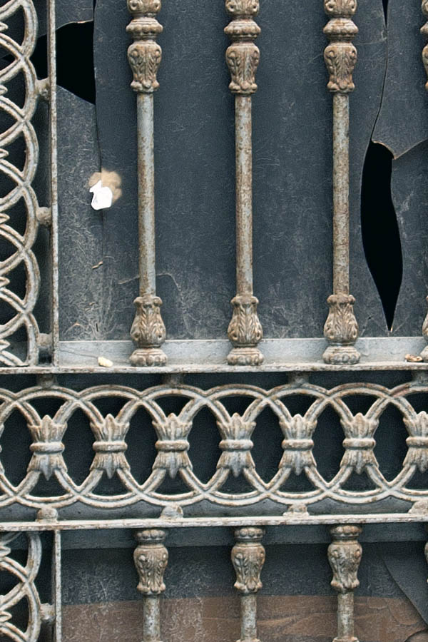 Photo 02818: Worn, unpainted metal door with top window