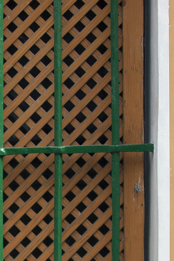 Photo 03282: Grated window on a light brown wall