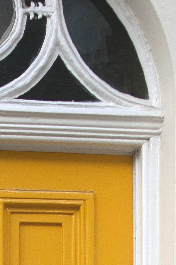 Photo 04611: Panelled, yellow door with decorated fan light
