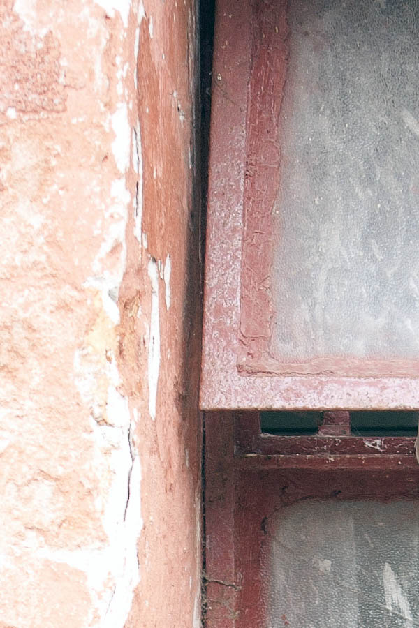 Photo 06314: Little, worn, red metal window with two frames