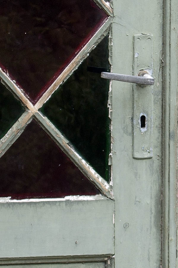 Photo 07372: Worn, panelled, light green double door with door light