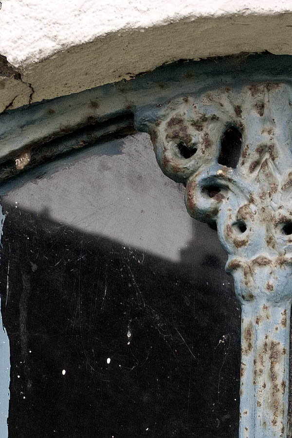 Photo 08321: Worn, light blue metal cast iron window