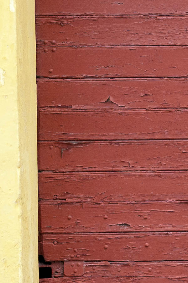 Photo 08344: Decayed, red garage door made of planks