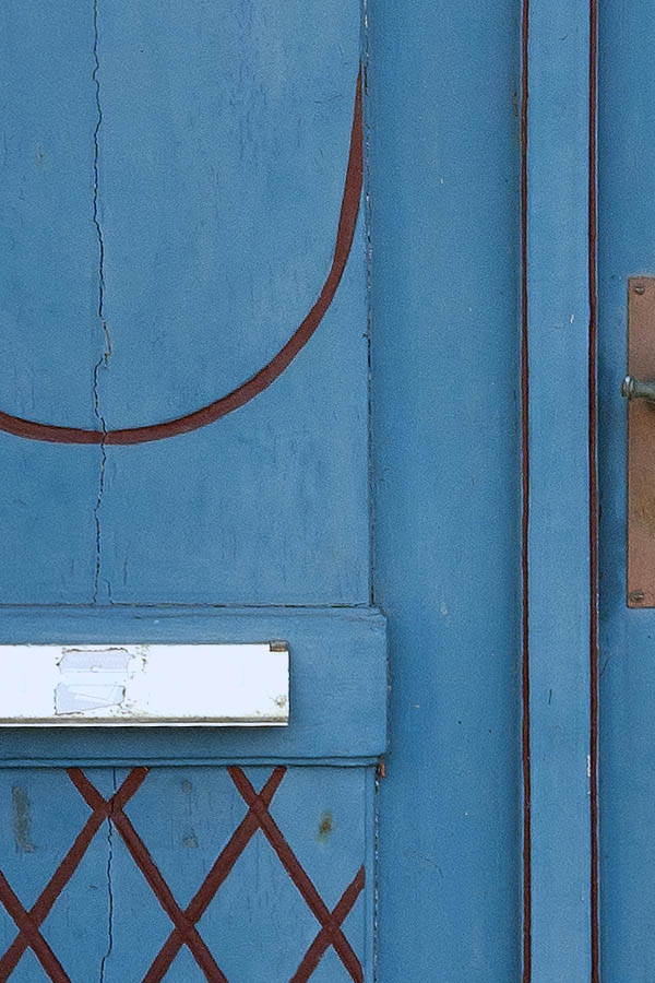 Photo 08735: Worn, carved, turquoise, red, and white double door with top window