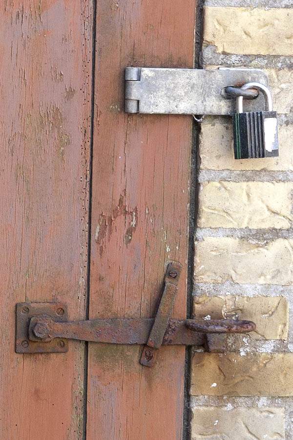 Photo 09154: Decayed, light brown door made of planks