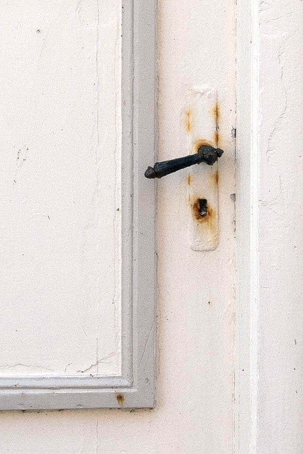 Photo 09376: Worn, panelled, grey and white door with top window