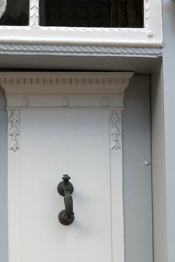 Photo 09384: Carved, panelled, grey and white door with top window