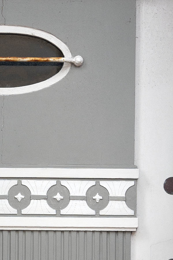 Photo 09405: Carved, panelled grey and white door with fan light and door light