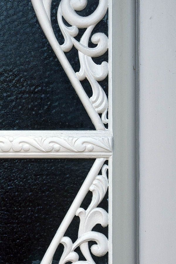 Photo 09414: Carved, panelled, grey, light grey, and white door with fan light and door light