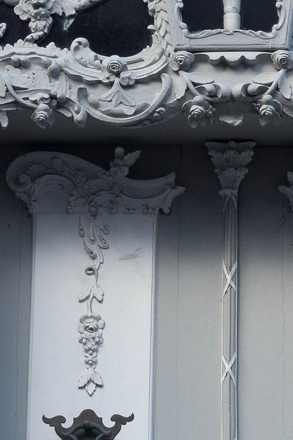 Photo 09456: Lavishly decorated, carved, grey and white double doors with top window 