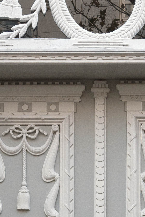 Photo 09463: Lavishly decorated, carved, grey and white double doors with top window 