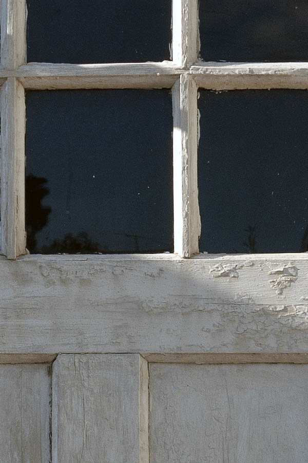 Photo 09475: Worn, panelled, white door with door light