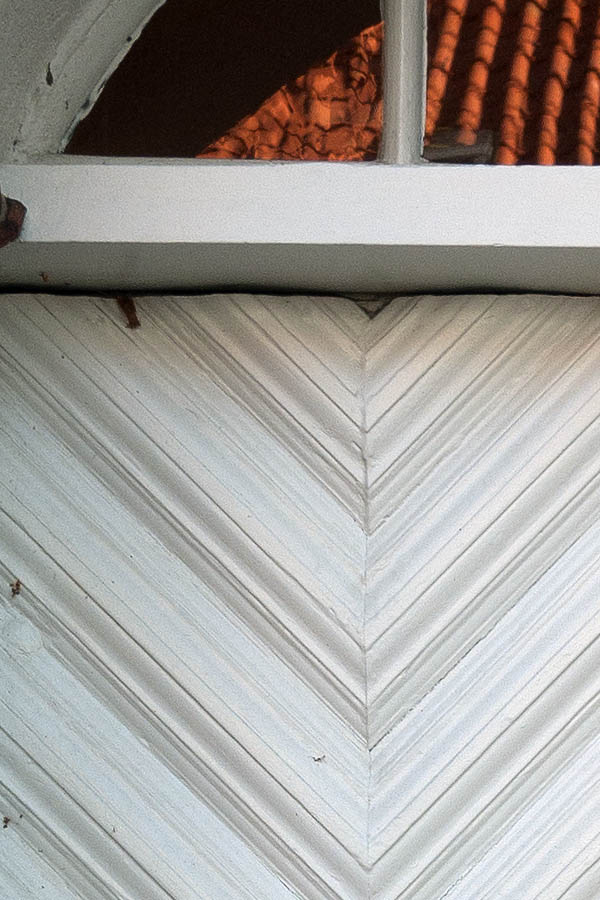 Photo 09592: White double door with diagonally mounted boards and fan light