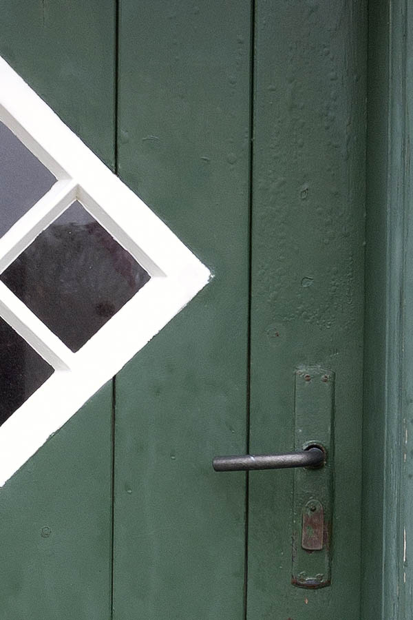 Photo 09673: Green half-door made of planks with a white, diamond-shaped door light