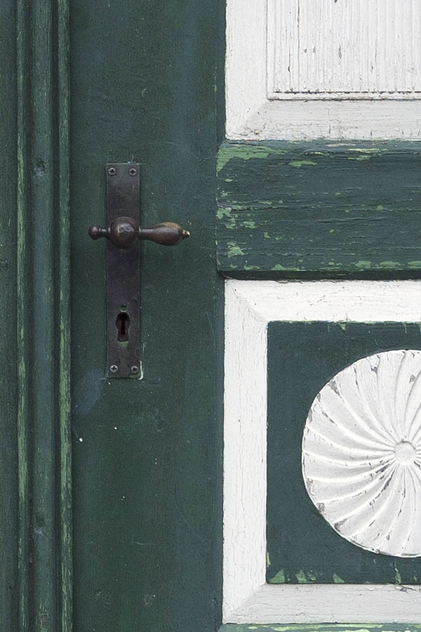 Photo 09803: Worn, carved, panelled, green and white double door with oval door lights