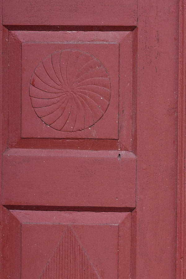 Photo 09831: Lopsided, carved, panelled, red and white double door with top window