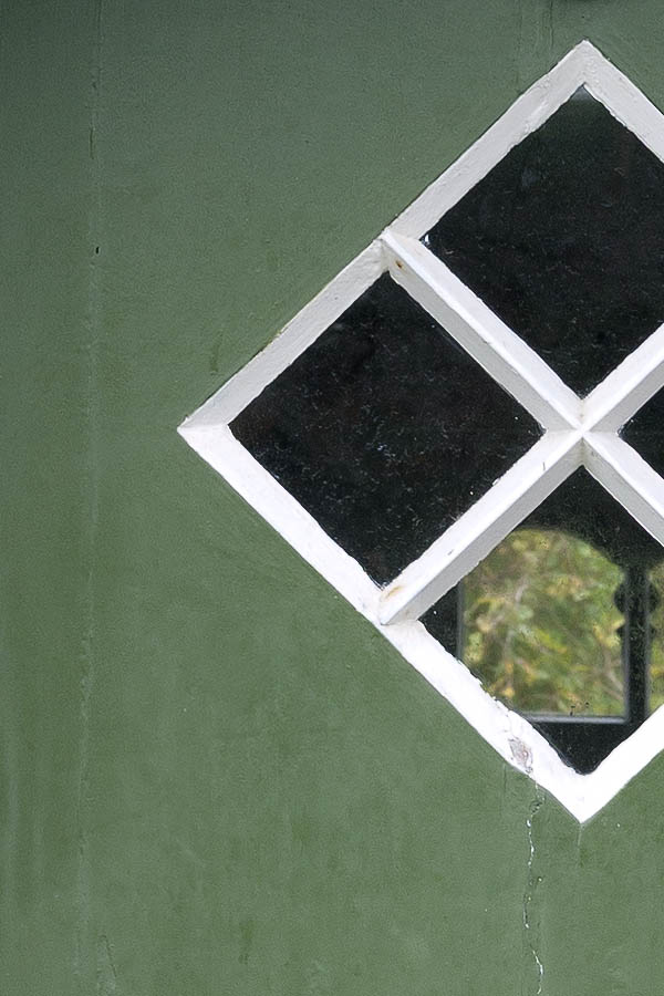 Photo 09845: Green, black and white half-door made of planks with a diamond-shaped door light
