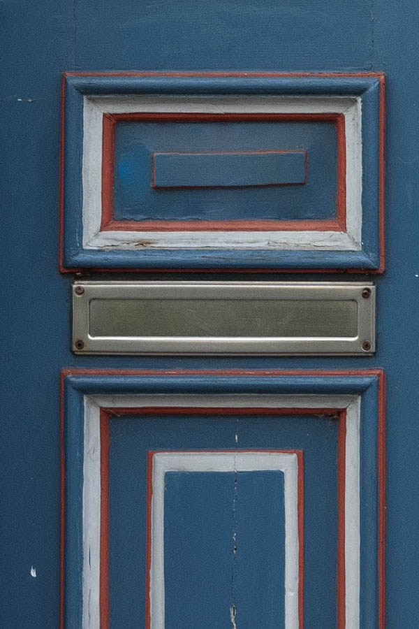 Photo 10691: Worn, panelled, blue, red and white double door with top window and door lights