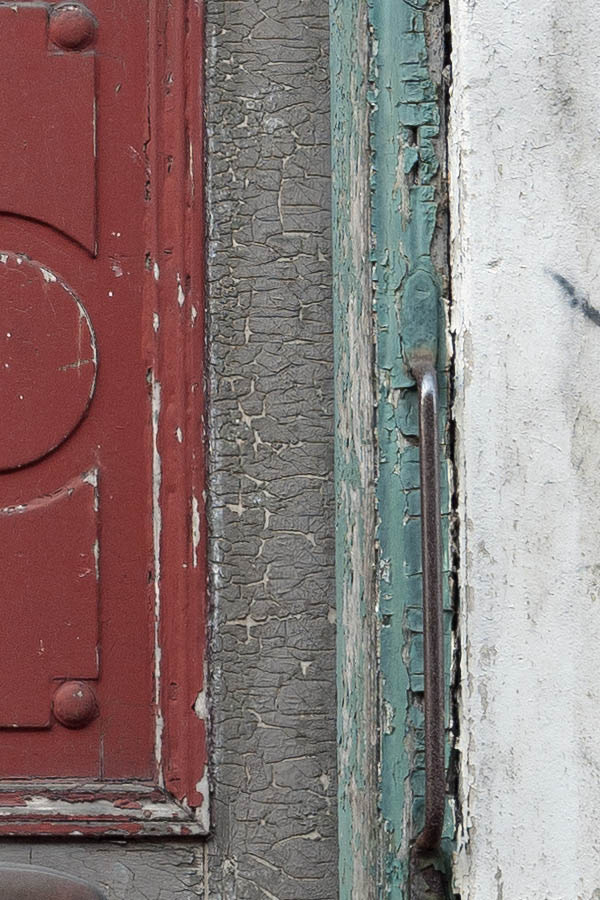 Photo 10778: Decayed, carved, panelled, red, brown and green double door with top window