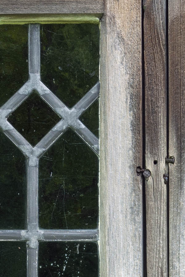 Photo 11335: Little, unpainted window with two frames and 34 panes