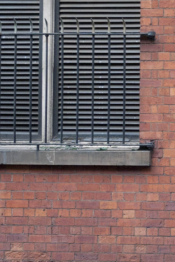 Photo 11512: Facade with large, white double door and large, grated windows