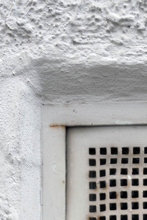 Photo 11836: White, rusty ventilation grating window