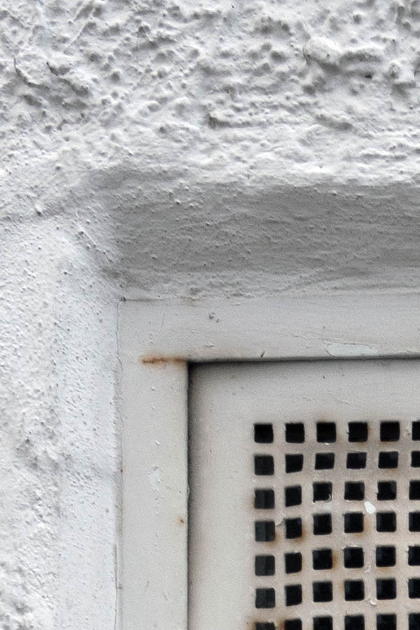 Photo 11836: White, rusty ventilation grating window