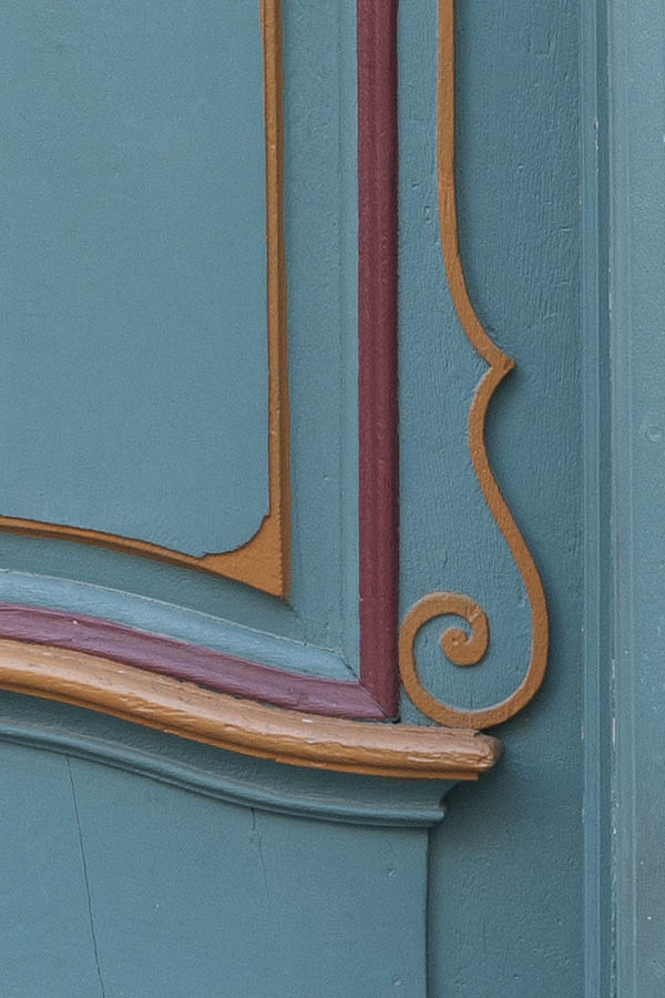 Photo 11873: Carved, panelled, teal, red and orange door with top window
