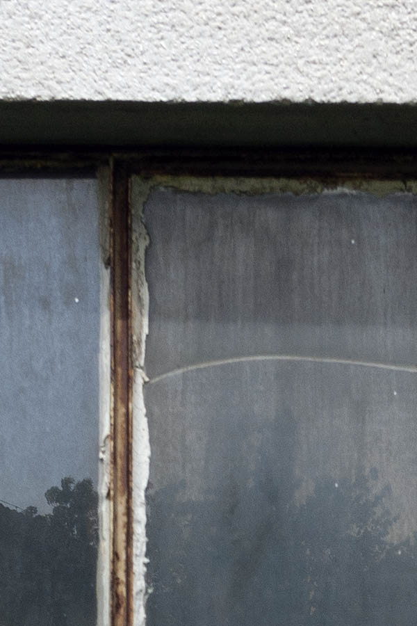 Photo 12003: Unpainted metal window with eight panes