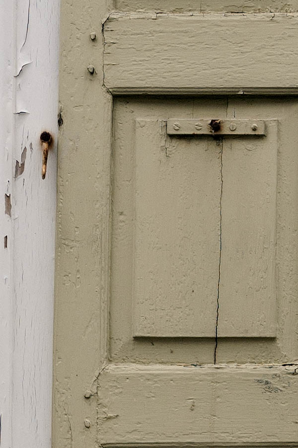 Photo 12132: Decayed, yellow shutters in a white frame