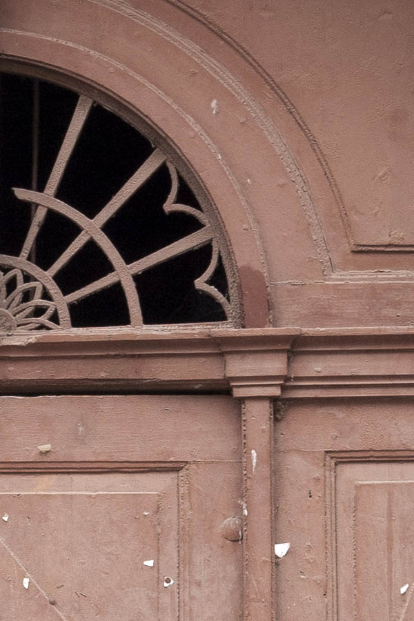 Photo 12351: Worn, panelled, light brown gate with fan light and minor door