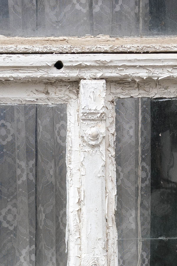 Photo 12536: Decayed, white and light blue window with three frames. .