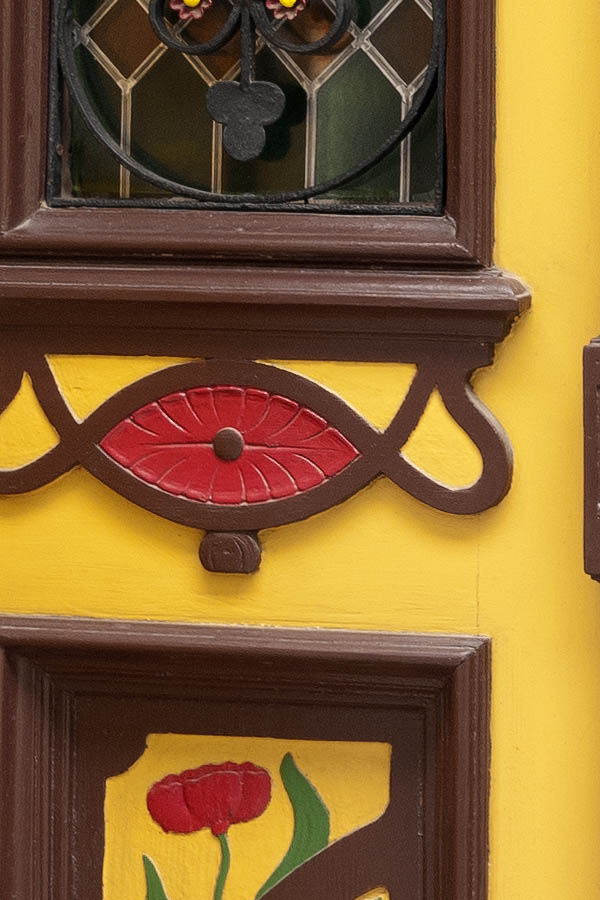Photo 12605: Panelled, yellow, brown, red and green double door within a green pilaster